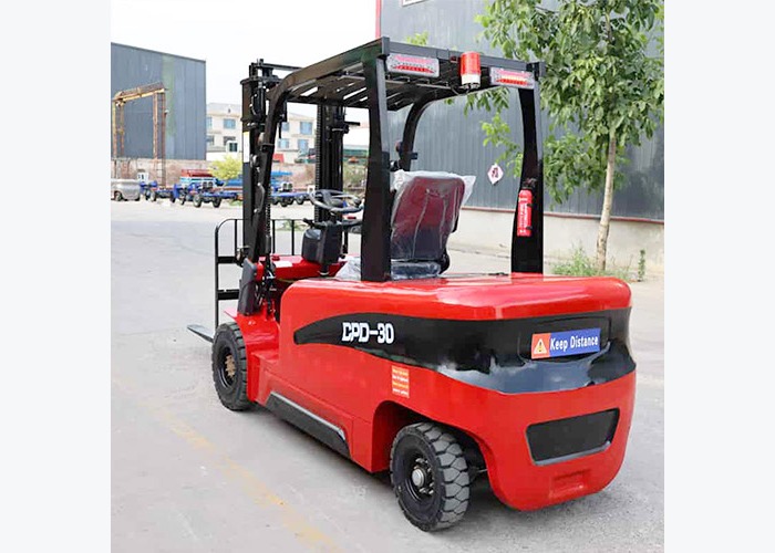 Electric forklift carrying pallet loads through an indoor warehouse route