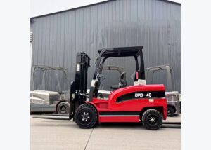 Electric forklift staged beside a charging point for charger compatibility planning