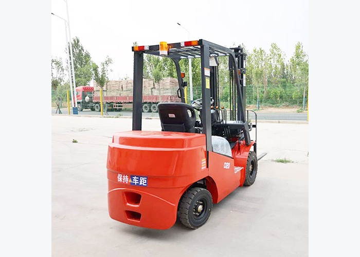 Electric forklift moving pallet loads through an indoor production warehouse