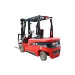 Electric forklift staged for battery runtime planning near a warehouse charging area