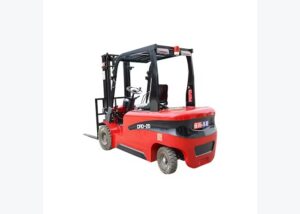 Electric forklift staged for battery runtime planning near a warehouse charging area