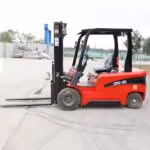 Electric forklift parked for troubleshooting slow travel and weak lift symptoms