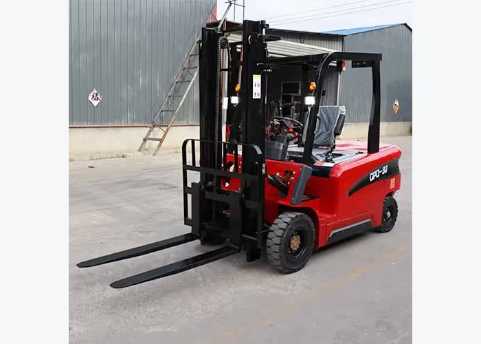 Electric forklift positioned near a battery handling area used for fleet charging strategy decisions