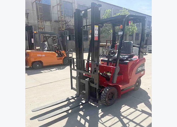 Mini electric forklift positioned for turning-radius and aisle-clearance review